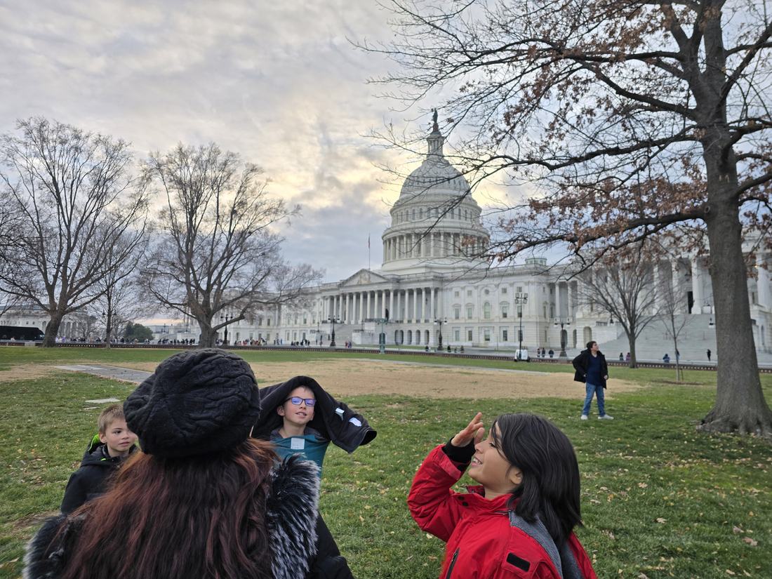 On the lawn in front of the Capitol at sunset