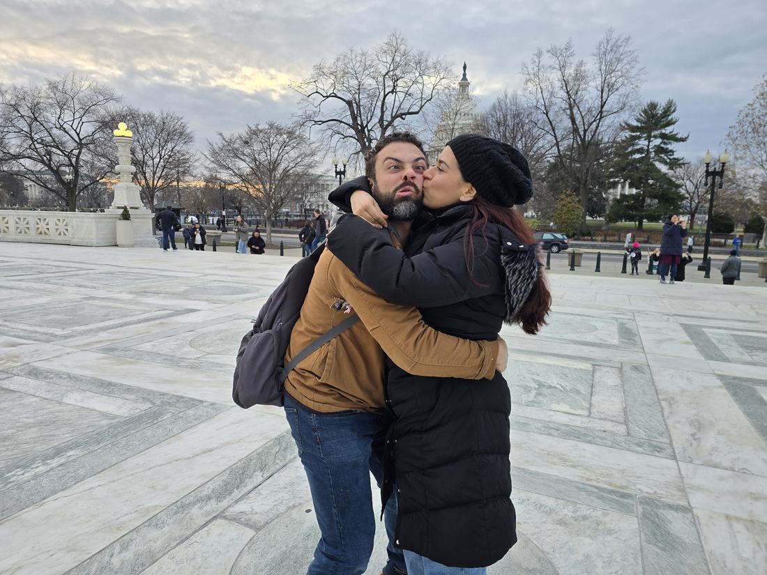 Nicole kissing Casey on the cheek in front of the Capitol