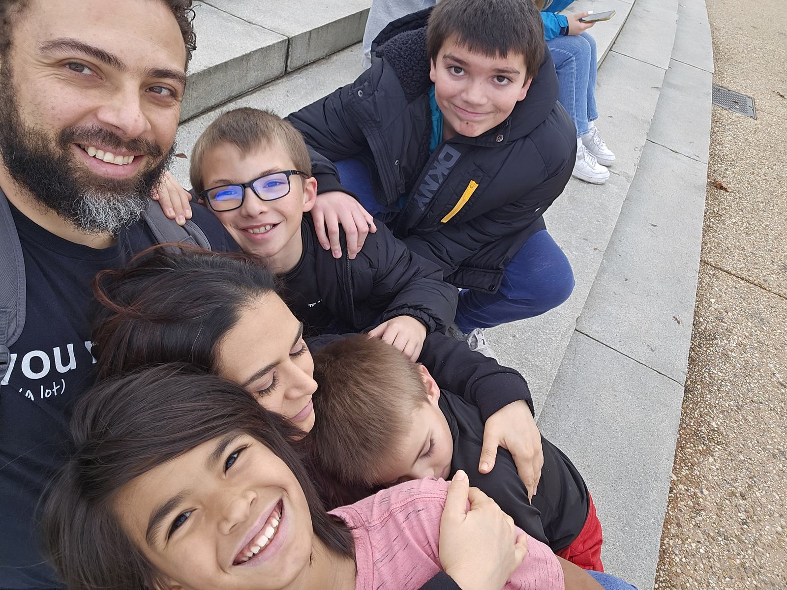 Casey, Nicole and all four children piled together on the steps in Washington DC